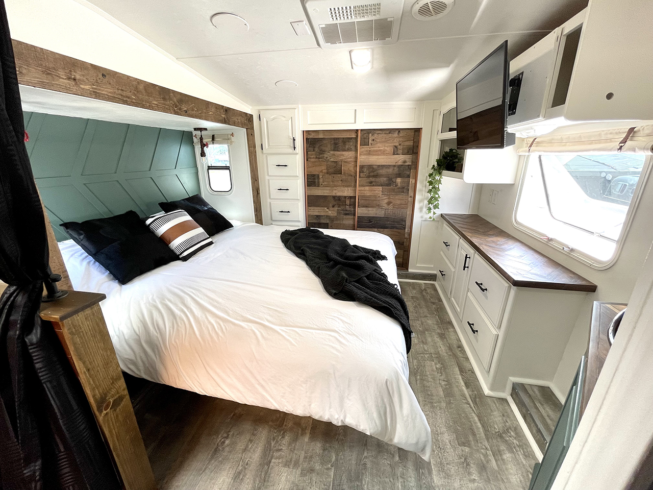 renovated RV bedroom with wood closet doors