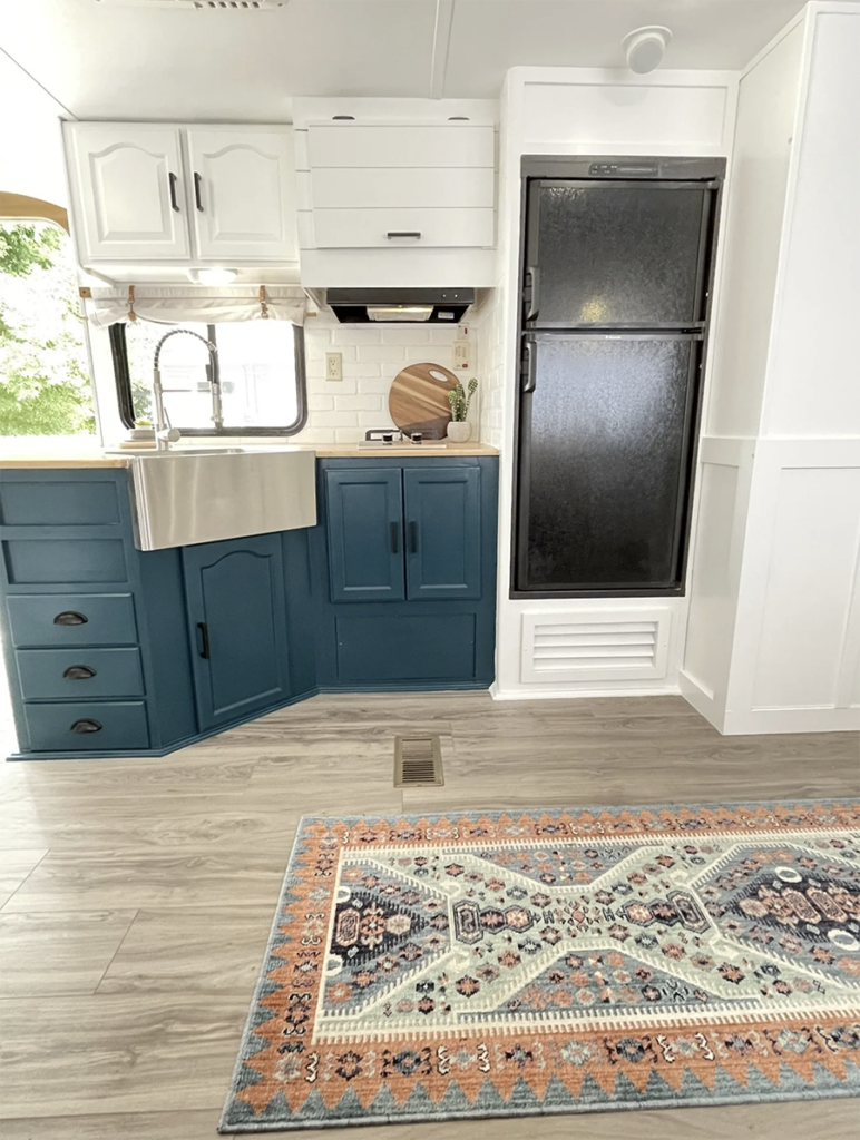 RV kitchen with blue cabinets